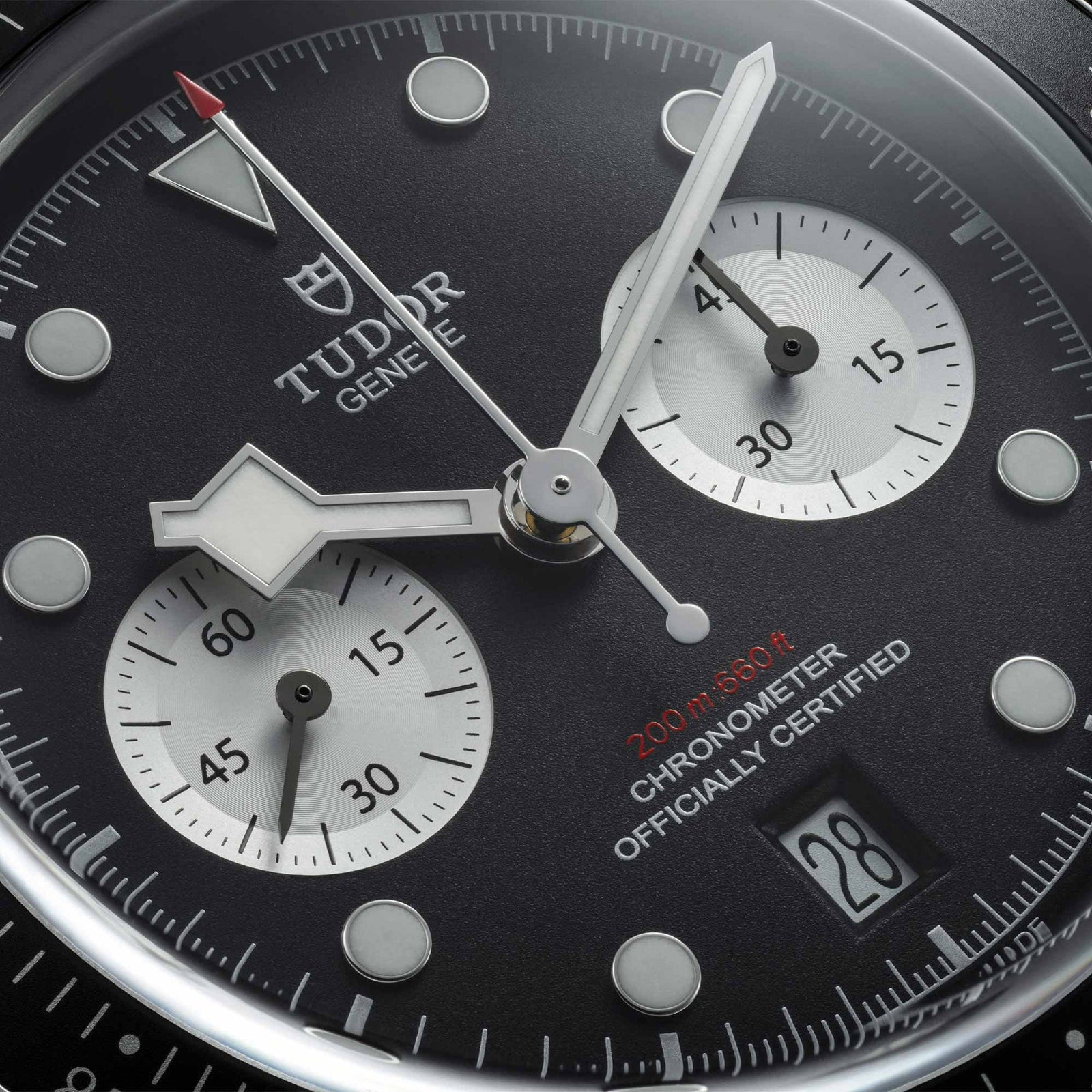 Close-up of the TUDOR Black Bay Chrono watch face featuring two subdials, a date window, and 200m water resistance text.