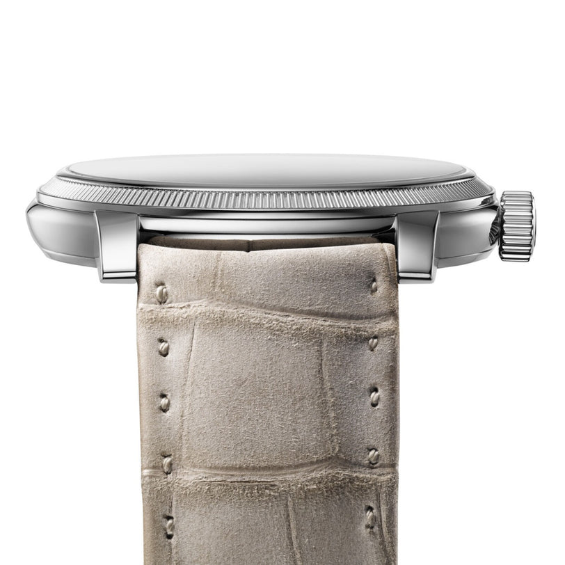 Side view of the Parmigiani Fleurier TORIC Petite Seconde, featuring a silver case, beige crocodile leather strap, and a textured crown.