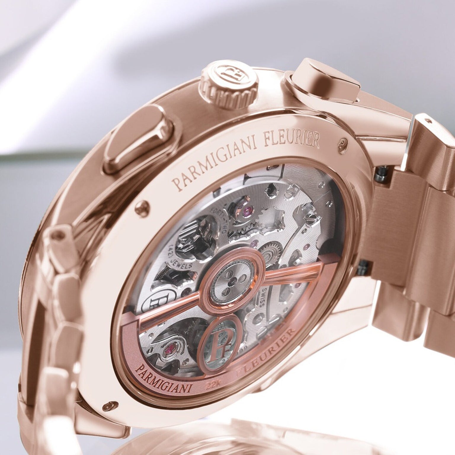 Close-up of a Parmigiani Fleurier TONDA PF Chronograph in rose gold, highlighting its intricate mechanical movement visible through the case back.