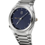 The Parmigiani Fleurier TONDA PF GMT Rattrapante features a textured dark blue dial, silver markers, and a metal bracelet.