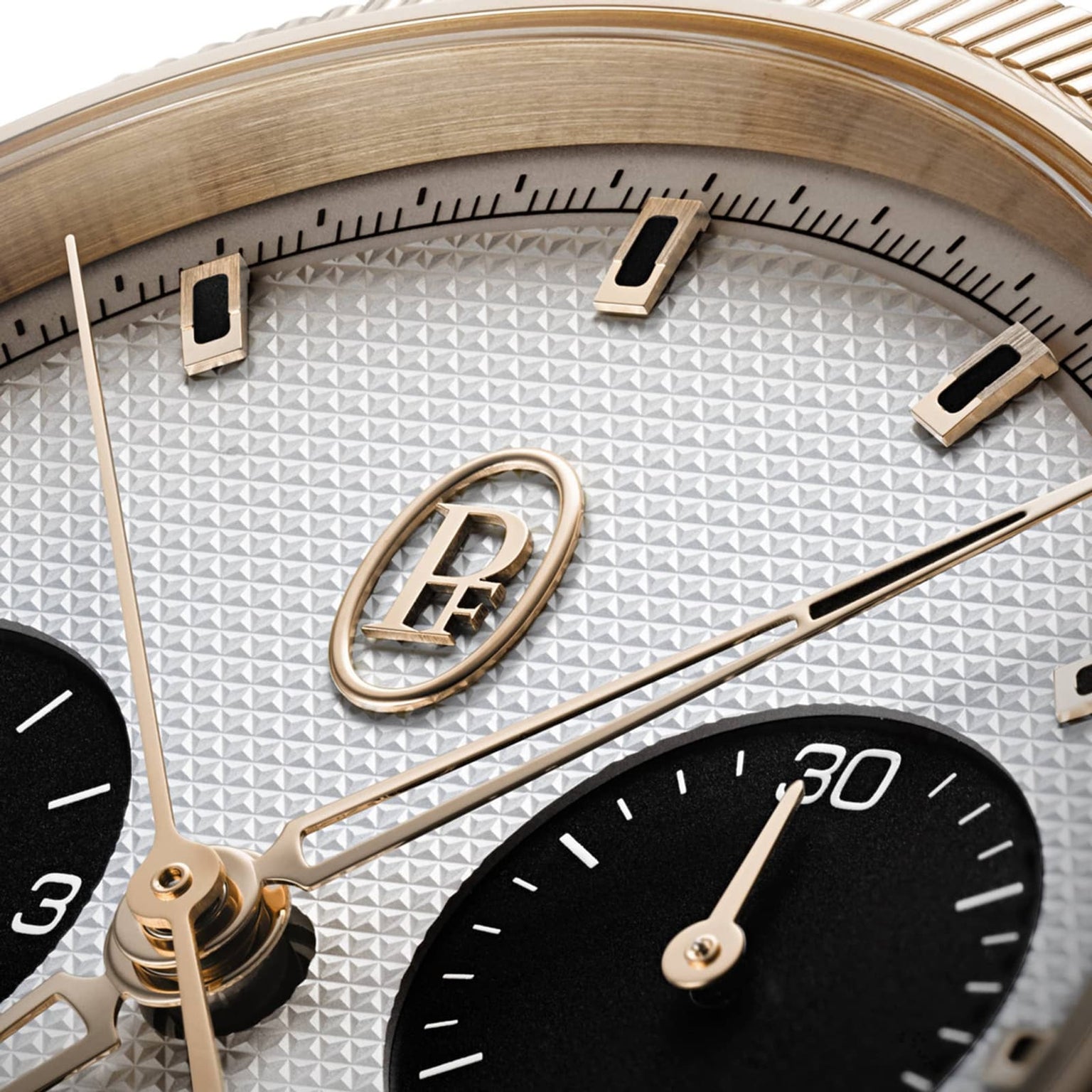 Close-up of the Parmigiani Fleurier TONDA PF Sport Chronograph watch face, featuring gold accents, a textured dial, and two black subdials.