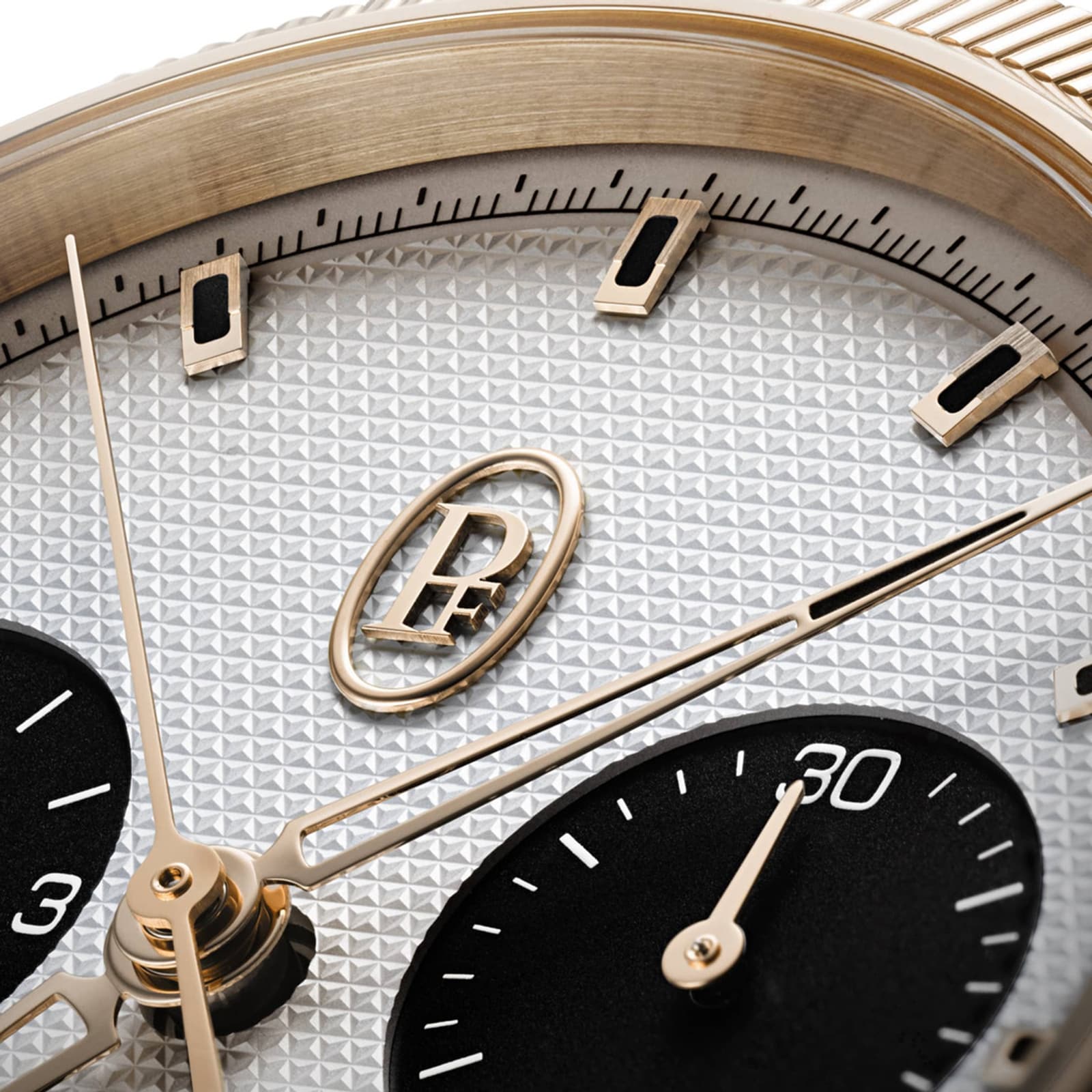 Close-up of the Parmigiani Fleurier TONDA PF Sport Chronograph watch face, featuring gold accents, a textured dial, and two black subdials.