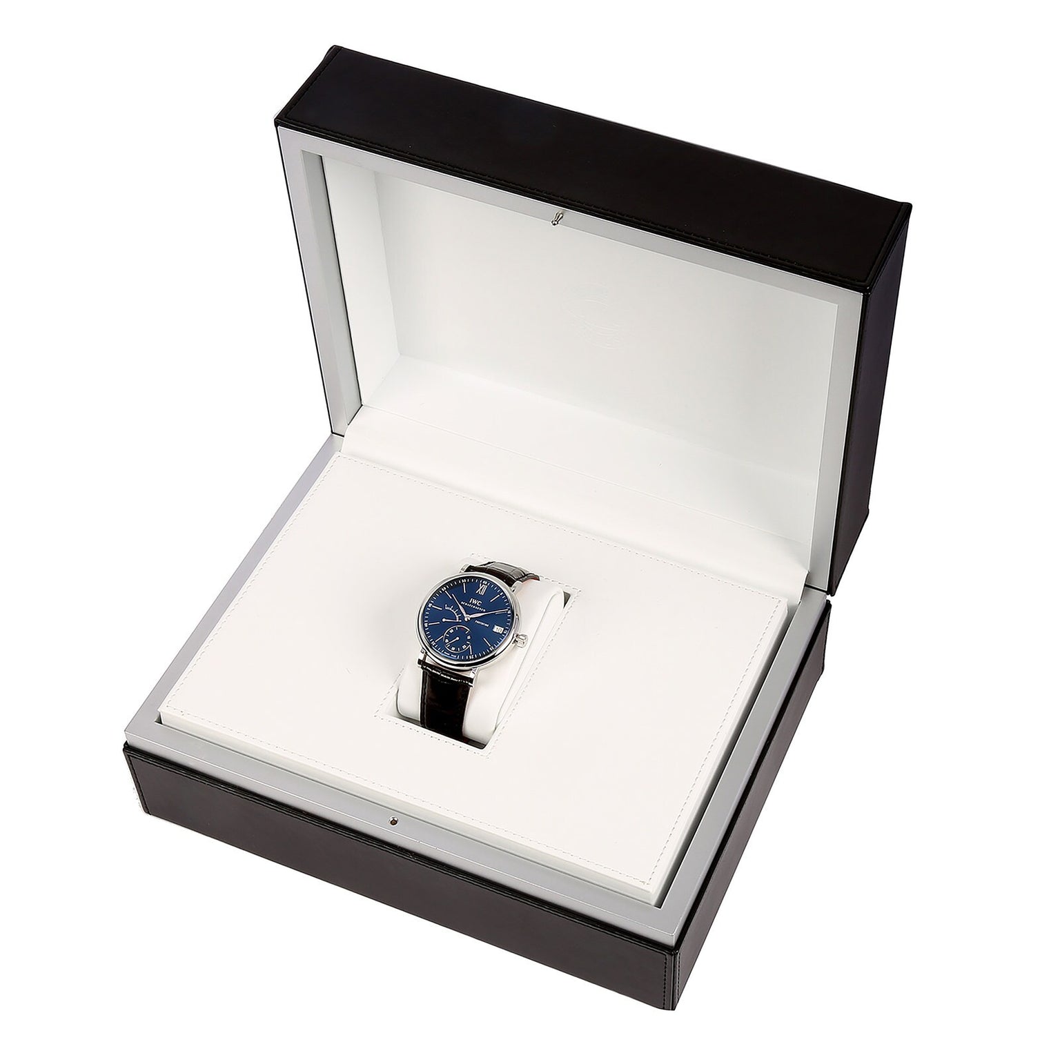 An IWC Schaffhausen Portofino Hand-Wound Eight Days watch, featuring a blue dial and black strap, is displayed inside an open white and black presentation box.