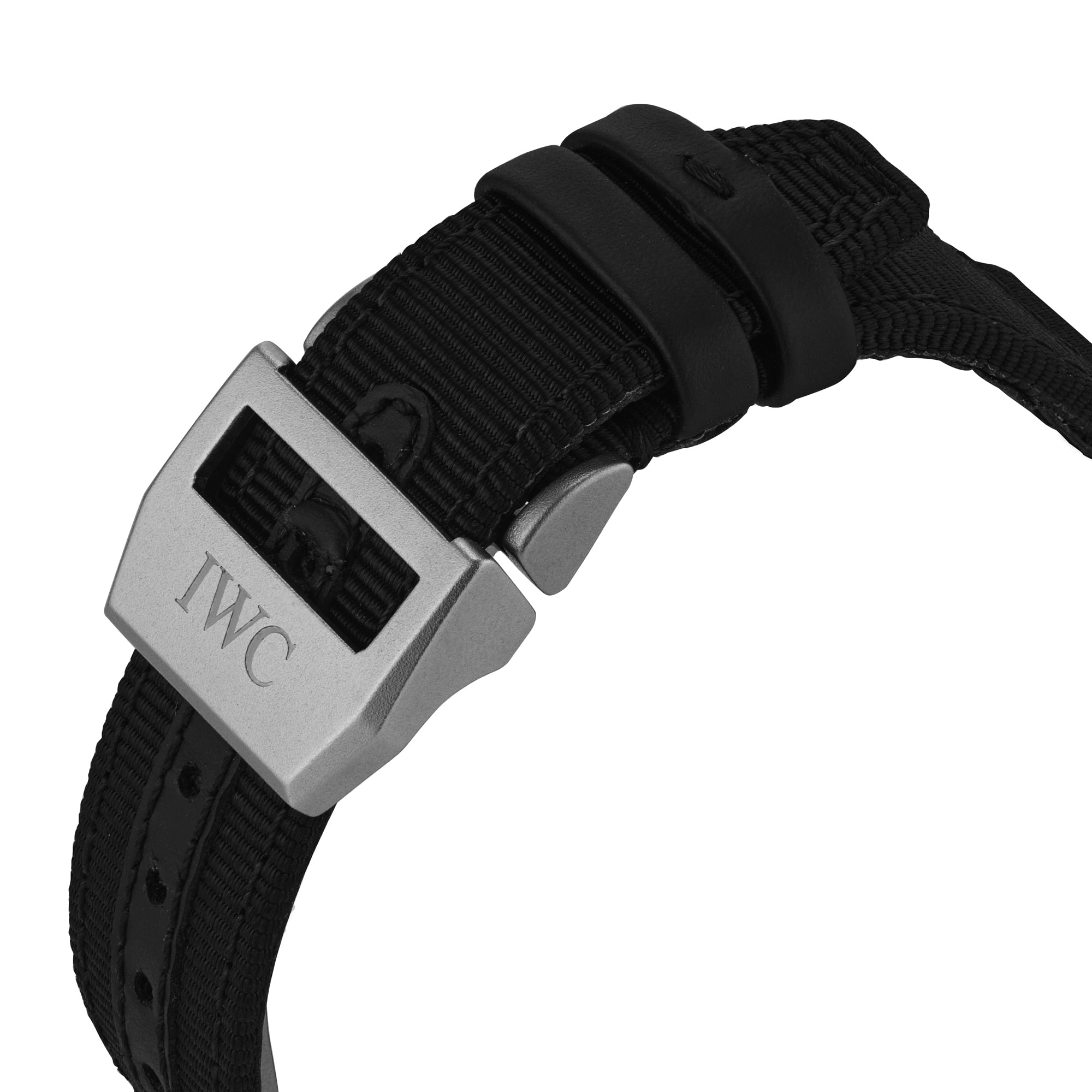 Close-up of a black fabric strap with a silver clasp engraved with IWC, from the IWC Schaffhausen Pilots Watch Chronograph Top Gun collection.