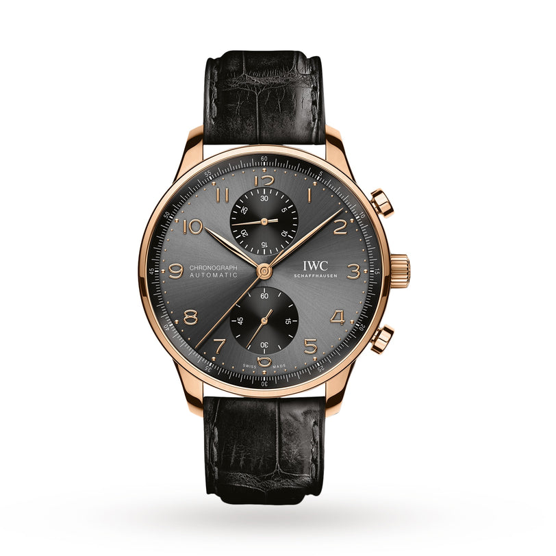 The IWC Schaffhausen Portugieser Chronograph features a gold case, gray dial with gold numerals, three subdials, and a black leather strap—captured on a white background and celebrated for its high-precision timekeeping.