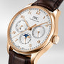 The IWC Schaffhausen Portugieser Perpetual Calendar 42 features a white dial, brown leather strap, 18ct gold case, gold hour markers, and subdials showing day, date, month, moon phase, and perpetual calendar functions.