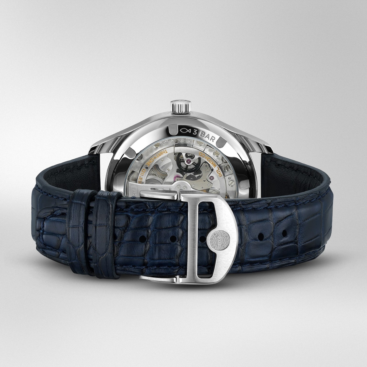 The IWC Schaffhausen Portugieser Automatic 40 features a blue leather strap and showcases its IWC-manufactured 82200 calibre movement through a transparent case back, set against a plain background.