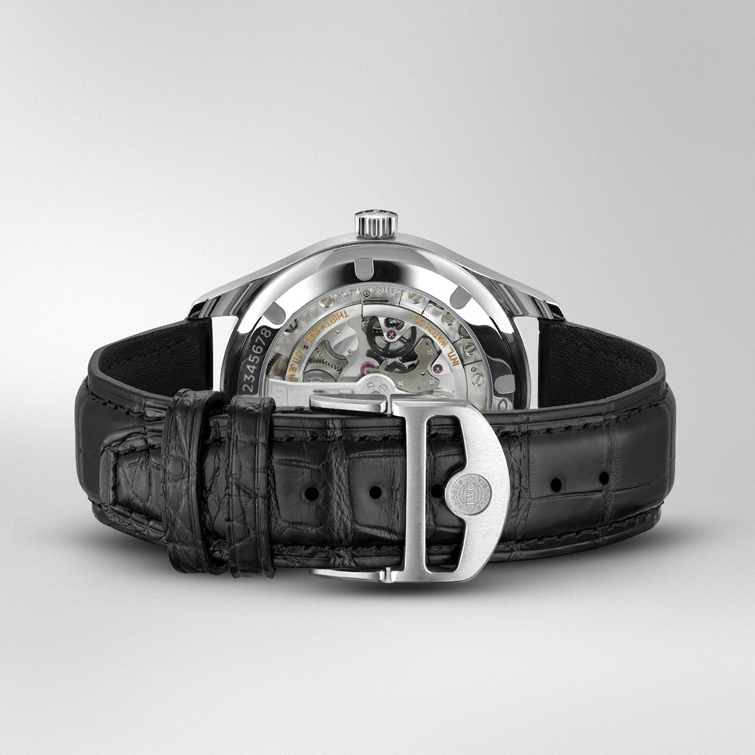 The IWC Schaffhausen Portugieser Automatic 40 showcases its visible 82200 calibre movement with Pellaton winding, black leather strap, and stainless steel buckle—viewable from the back for a touch of luxury.