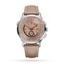 The Patek Philippe Complications 5935A-001 is a luxury watch with a tan leather strap, world time cities on the dial, and a rose gold textured face.