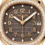 Close-up of a Patek Philippe Aquanaut 5268/200R-010 watch with a brown face, gold hands, and a diamond bezel, displaying the date as 18.