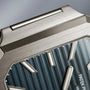 Close-up of the Patek Philippe Cubitus 7128/1G-001 luxury watch face with a brushed metal case and blue textured dial featuring silver hour markers.