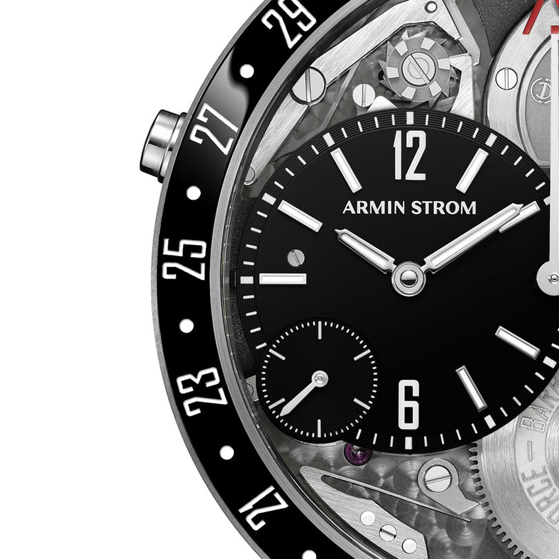 Close-up of the Armin Strom Orbit Manufacture Edition, showcasing a black ceramic bezel with white numerals, a black dial with white markers, small seconds subdial, exposed gears, and striking mechanical details.