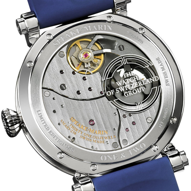 Back view of the Speake Marin Dual Time Watches of Switzerland Group Edition Blue, featuring an exposed movement, engraved text, and visible blue strap.
