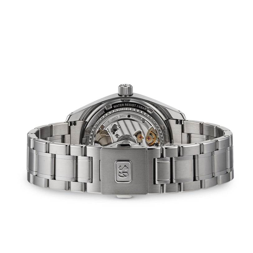 Back view of the Grand Seiko Spring Drive Heritage wristwatch, featuring a titanium case, open case back displaying its mechanical movement, and engraved water resistance details.