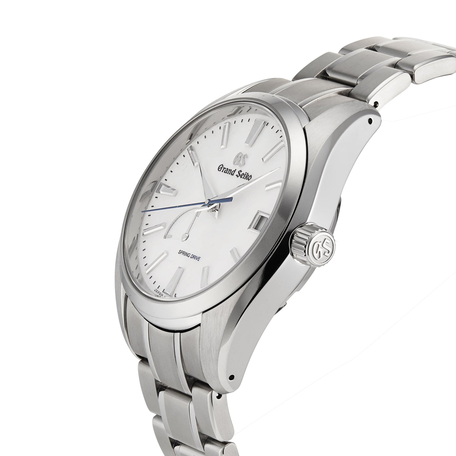 The Grand Seiko Spring Drive Heritage wristwatch features a white dial, silver hour markers, and a stainless steel bracelet, shown at an angle to highlight its precise Spring Drive movement.
