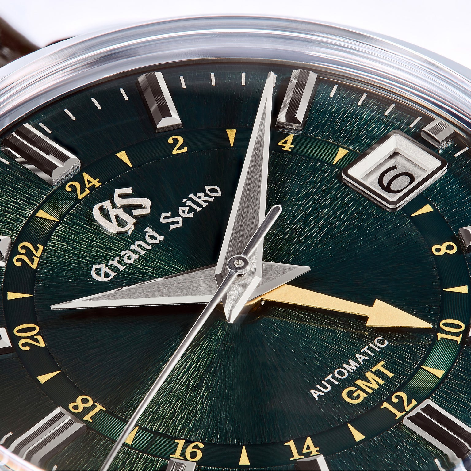 Close-up of a Grand Seiko Automatic GMT Elegance, featuring a British Racing Green Mount Iwate dial with time, date, and 24-hour markers—crafted to Grand Seiko Standard.