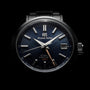 The Grand Seiko Hi-Beat GMT Heritage features Zaratsu polishing, a dark textured dial with silver markers and hands, a date window at 3 o’clock, and “GMT” in gold above 6 o’clock.