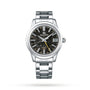 The Grand Seiko Spring Drive Elegance features a stainless steel case, textured black dial, yellow GMT hand, date at 3 oclock, and silver bracelet—showcasing precise Spring Drive movement that mirrors the changing seasons.