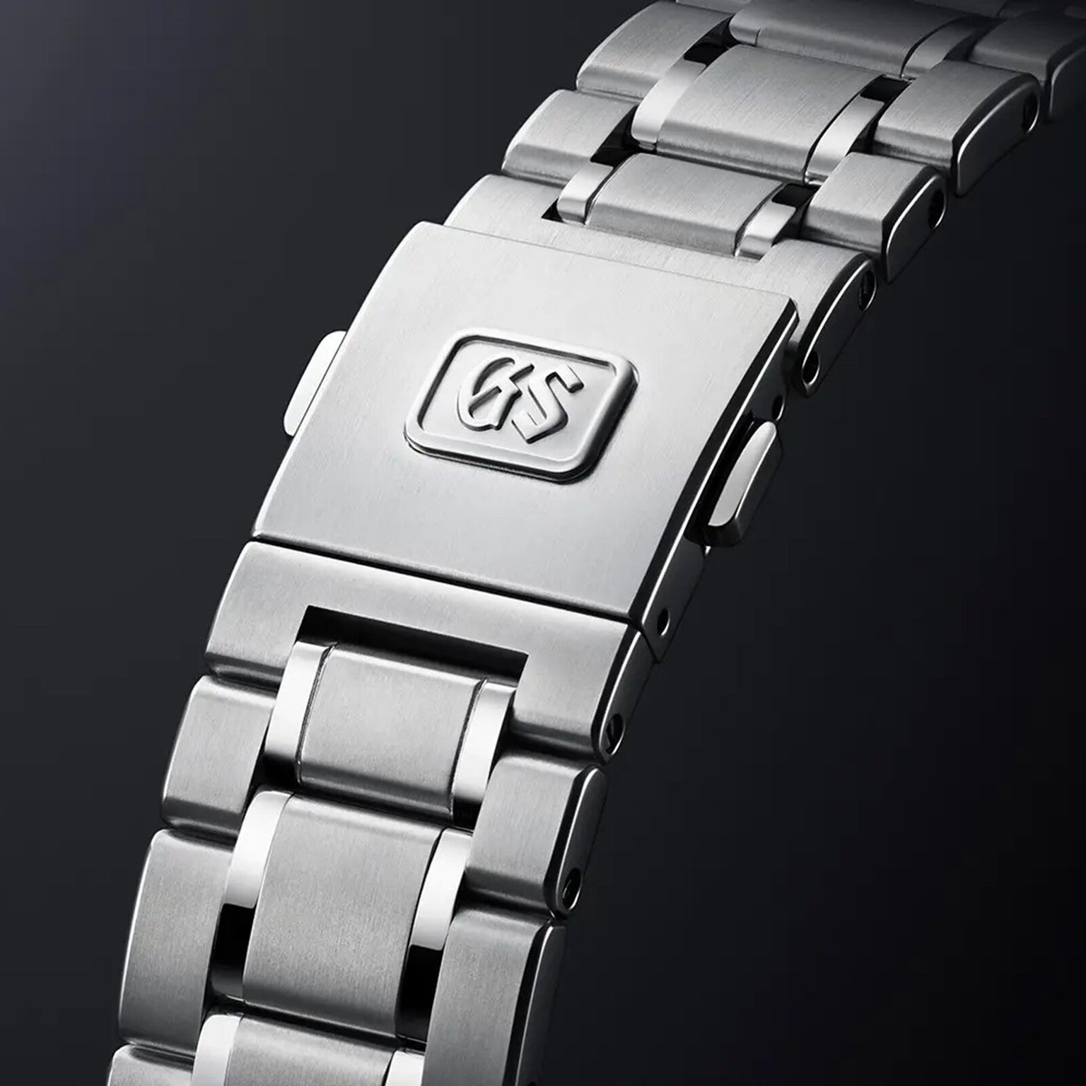 Close-up of the Hi-Beat Heritage stainless steel bracelet with clasp, featuring the Grand Seiko logo engraved—showcasing precision and craftsmanship, handmade in Japan.