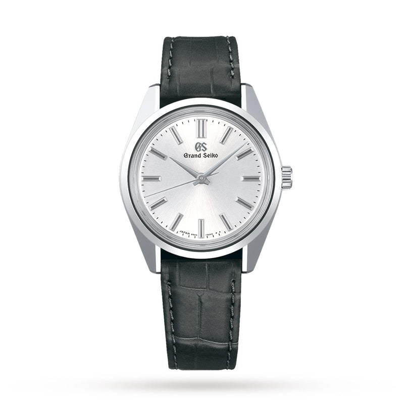 The Grand Seiko Manual Heritage wristwatch features the iconic 44GS design, a white sunray pattern dial, silver hour markers, and a black leather strap, displayed on a white background.