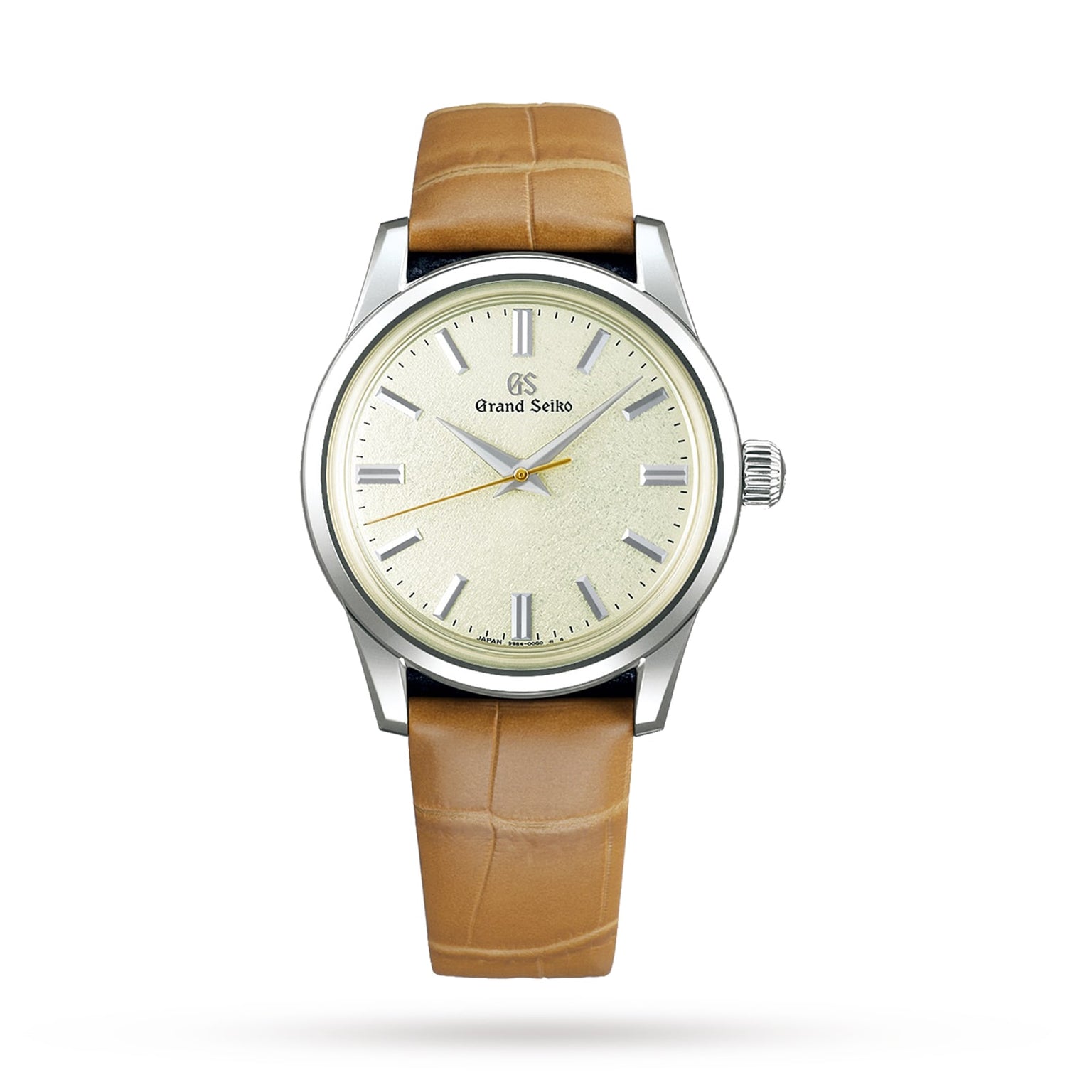 The Grand Seiko Manual Elegance features a light tan leather strap, silver case, and cream dial with silver markers and hands—an example of innovative craftsmanship. The brand name is displayed on the watch face.