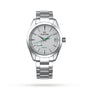 The Grand Seiko Spring Drive Heritage is a stainless steel wristwatch with Japanese craftsmanship, a silver dial, green second hand, Spring Drive movement, date at 3 oclock, and a metal link bracelet.
