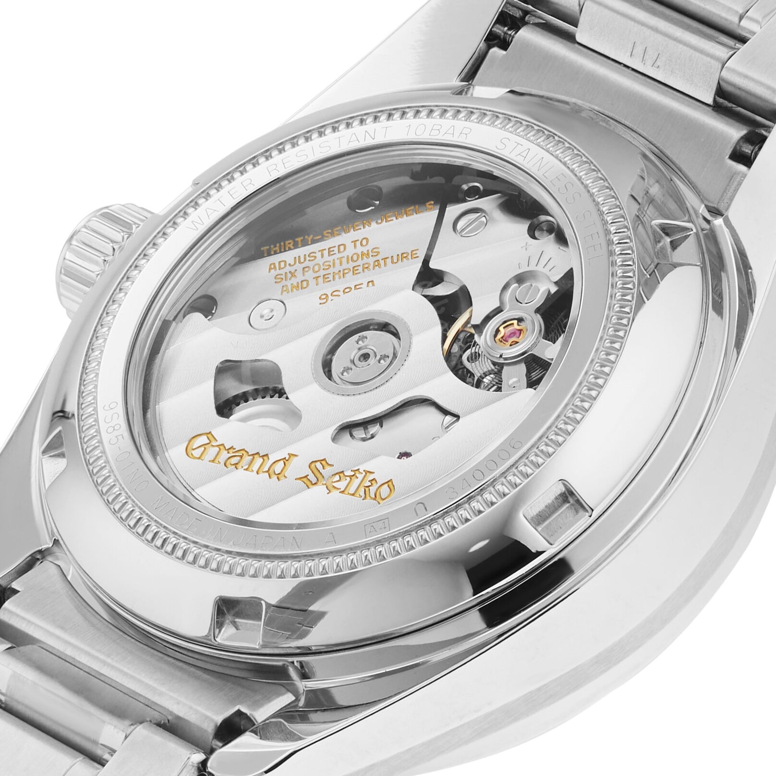 Close-up view of a Grand Seiko Hi-Beat Heritage watch, highlighting the exhibition case back and intricate movement visible through an Ever-Brilliant Steel transparent cover.