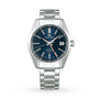 The Grand Seiko Hi-Beat GMT Heritage watch features a blue dial, silver hour markers, date window at 3 o’clock, stainless steel case, and a silver bracelet.