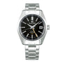 The Grand Seiko Hi-Beat GMT Heritage is a stainless steel watch with a black dial, silver hour markers, date at 3 oclock, metal bracelet, and precise 9S86 automatic movement.