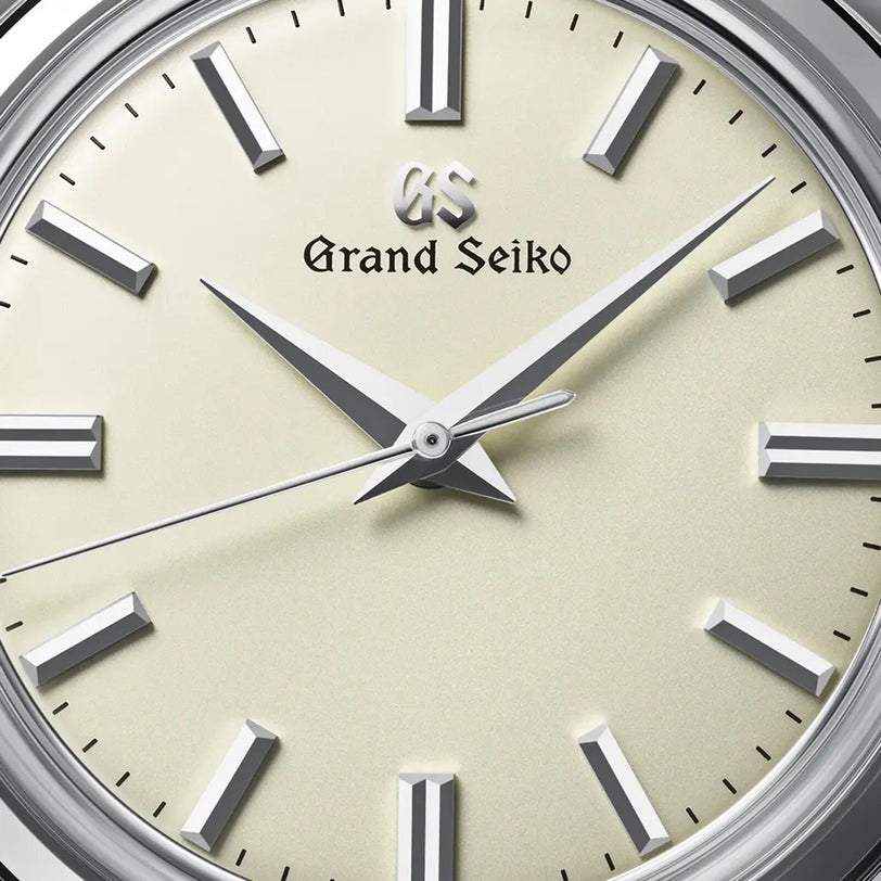 Close-up of a Grand Seiko Manual Elegance watch face featuring silver hour markers and hands on a cream dial, displaying 10:08:36 and powered by the precise 9S64 mechanical calibre movement.