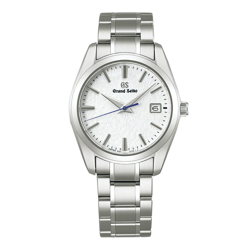 The Grand Seiko Quartz Heritage features a snowflake dial, silver hour markers, blue second hand, date at 3 o’clock, and a stainless steel bracelet in a sleek 37mm titanium case.