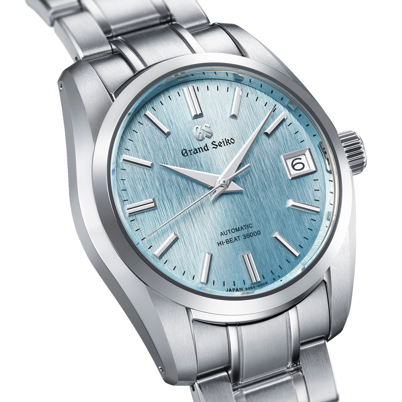A close-up of the Grand Seiko Hi-Beat Heritage wristwatch, featuring a stainless steel case, light blue textured dial, date window at 3 o’clock, and a silver metal bracelet.