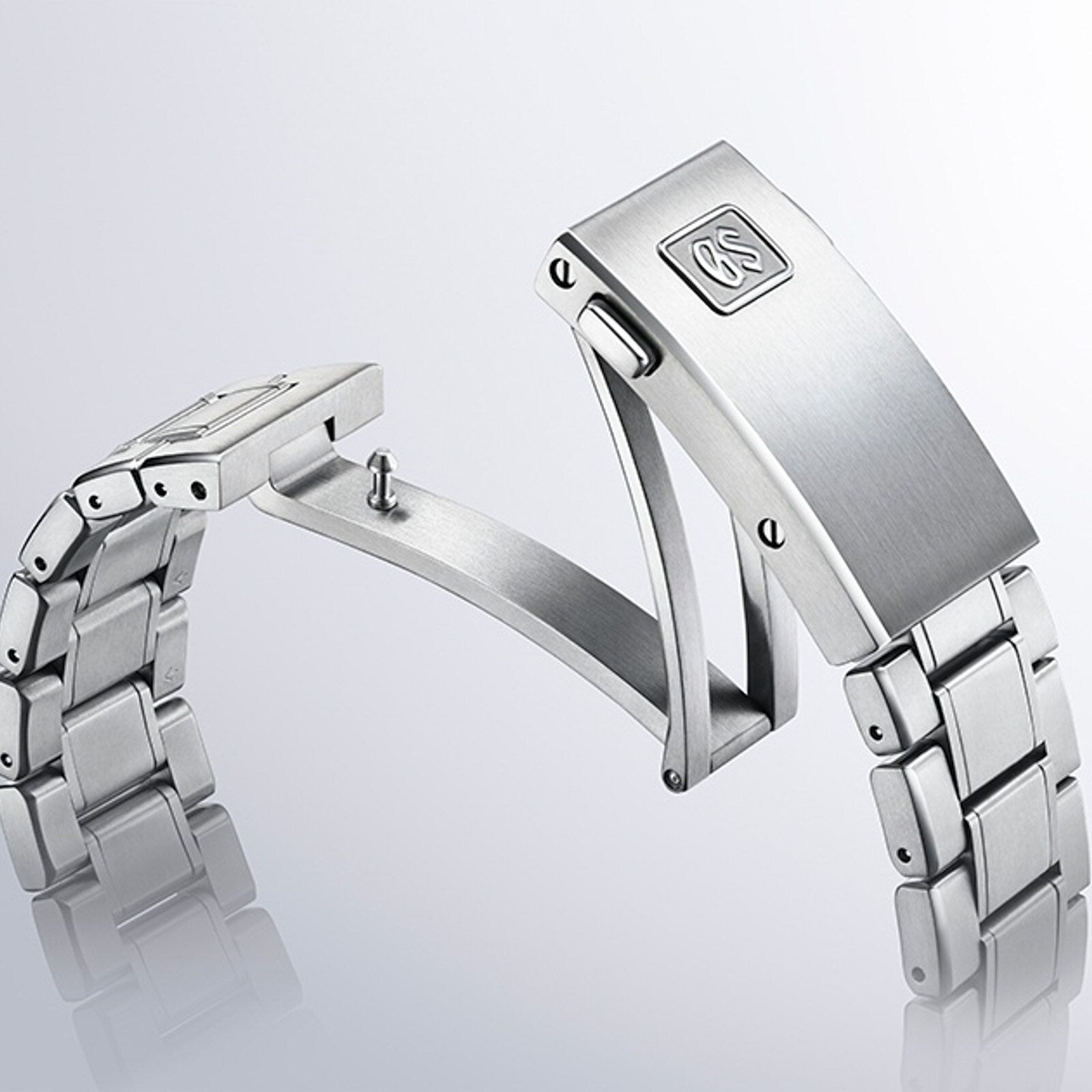 Grand Seiko Spring Drive U.F.A Evolution 9 watch bracelet in silver metal, featuring a partially open deployment clasp, displayed on a light background.