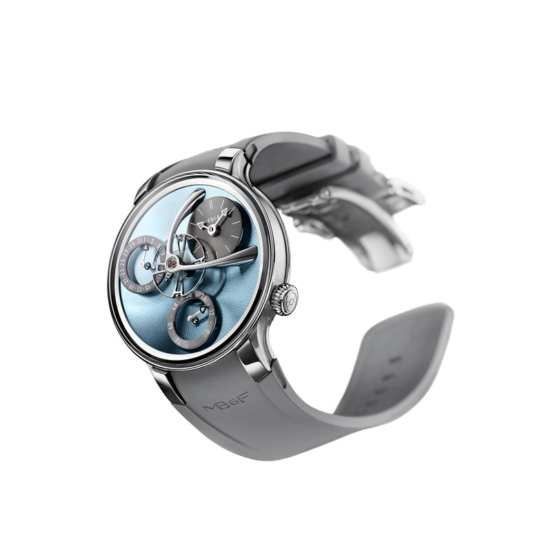 The MB&F Legacy Machine Split Escapement EVO is a luxury watch featuring a blue dial, exposed mechanics, and a grey strap, shown on a white background.