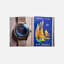 The open Watches: A Guide By HODINKEE by Hodinkee displays a wristwatch on the left page and a vintage North America Air France poster on the right, ideal for fans of classic timepieces.