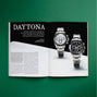 An open spread from HODINKEE Magazine, Volume 11 by Hodinkee showcases two Rolex Daytona watches on green with the headline DAYTONA—a bold celebration of iconic horological Bauhaus-inspired design.