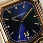 Close-up of the Gerald Charles Maestro 2.0 Ultra-Thin wristwatch with a royal blue sunburst dial, gold hour markers and hands, 18K Rose Gold 4N case, vulcanised rubber strap, and a date window displaying the number 13.