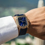 A wrist with the Gerald Charles Maestro 2.0 Ultra-Thin watch, featuring an 18K Rose Gold 4N case, royal blue sunburst dial, date display, and vulcanised rubber strap, worn with a crisp white dress shirt.