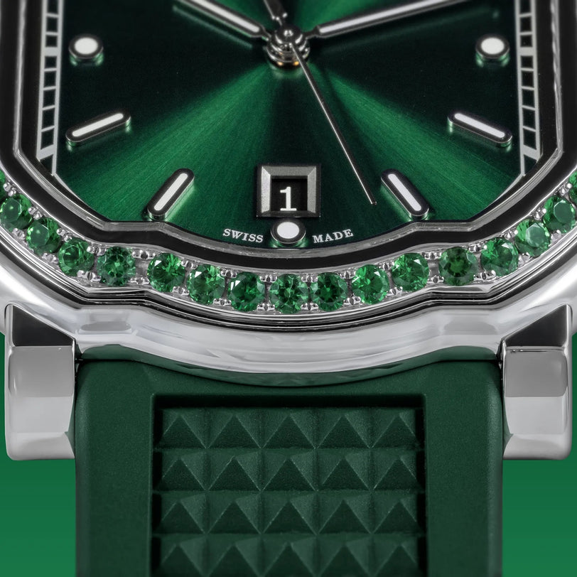Close-up of the Gerald Charles Maestro 2.0 Ultra-Thin Gem-Set, featuring an emerald green sunburst dial, date window, gemstone accents, textured green strap, and SWISS MADE label below the date display.