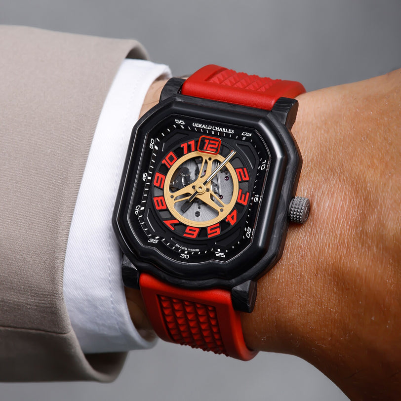 Close-up of a wrist wearing the Gerald Charles Maestro 4.0 Ducati 30° Anniversario 916, a sporty black and red watch with large red numbers and a visible gear mechanism.