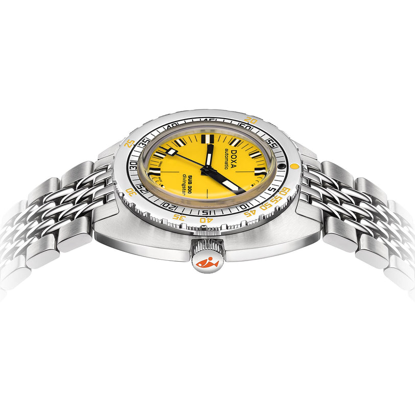 The DOXA Sub 300 Divingstar is a stainless steel divers watch featuring a yellow dial, silver unidirectional bezel, and metal bracelet, shown from a low angle.