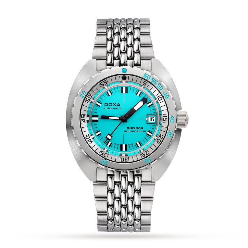 The DOXA Sub 300 Aquamarine is a stainless steel diver’s watch with a turquoise dial, unidirectional bezel, date window at 3 o’clock, silver hour markers, and a metal bracelet.