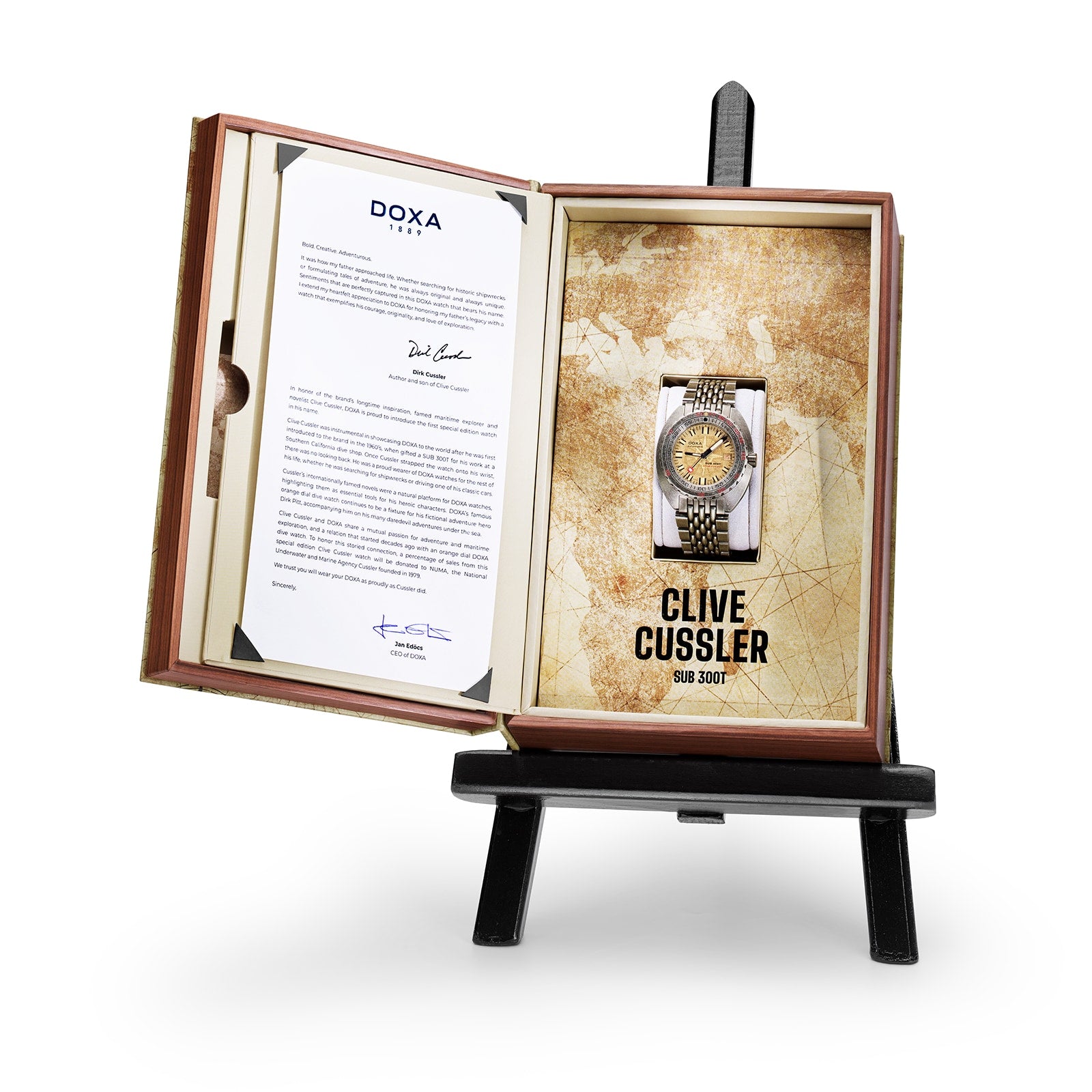 The DOXA Sub 300T Clive Cussler watch, boxed and displayed on an easel, features a Swiss automatic movement and helium release valve, with map-themed packaging and a letter-inspired background inside the box.