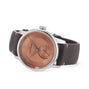 The Louis Erard Petite Seconde Terracotta 42 features a brown leather strap and a copper-colored dial with blue hands.