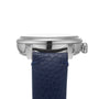 Side view of the Louis Erard Petite Seconde Bleu Nuit, a silver wristwatch with a blue leather strap, set against a white background.