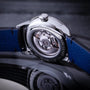 Close-up of the Louis Erard Guilloché Main II showcasing its exposed mechanical movement and blue leather strap.