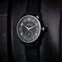 Louis Erard Petite Seconde Guilloché Anthracite Black wristwatch with a textured dial and leather strap, displayed against a dark background.