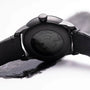 Close-up of the back of the Louis Erard Le Régulateur Louis Erard x Olivier Mosset wristwatch, showing its visible inner mechanism and black leather strap.