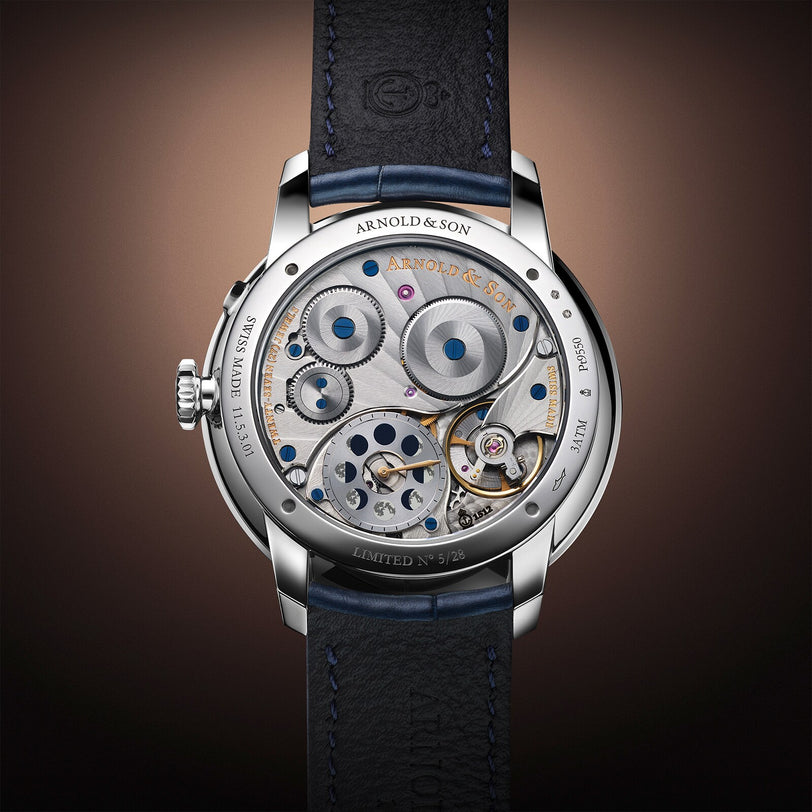 Close-up of the Arnold & Son Perpetual Moon 41.5mm Platinum showcasing its exposed mechanical movement, intricate gears, and elegant leather strap.
