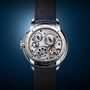 The back of the Arnold & Son Perpetual Moon 41.5mm Platinum watch displays exposed gears and intricate mechanical details.